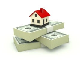 house sitting on stack of money